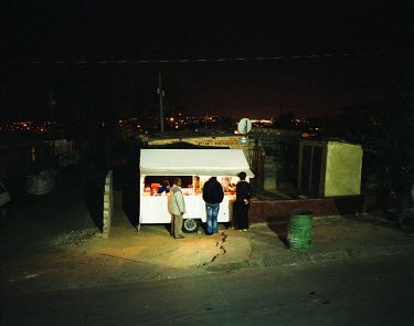People come to buy home made tripe from a small mobile take away van in Alexandra, one of the large townships in the centre of Johannesburg. The van parks up every night opposite a new trendy bar whic...