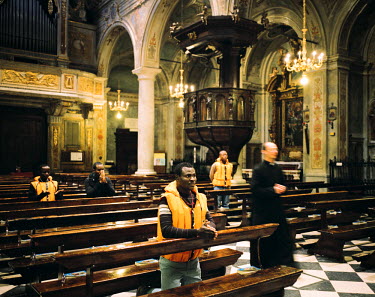 Christian African migrants pray in the church of Edolo where they also recieve Italian lessons.