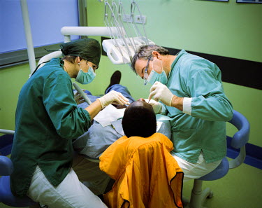 A Zambian migrant undergoes dental treatment in Esine hospital.