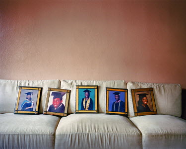 Portraits of Bilikiss Adebiyi's (director of Wecyclers) brothers and sisters, on her parent's sofa. They all studied at university in England or the United States. Their middle class parents made impo...