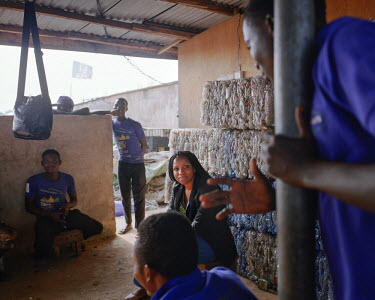 Bilikiss Adebiyi, founder and director of Wecyclers, chats with employees in one of the hubs at the end of the day. Wecyclers has created around 50 jobs in two years, in the poorer neighbourhoods, wit...