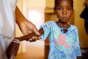Hamsa Souley (35) and daughter Kaya Salay (five years old), who’s suffering with malnutrition, receives a hygiene kit at the Banneberi Treatment Centre. The natural treatment duration for children w...