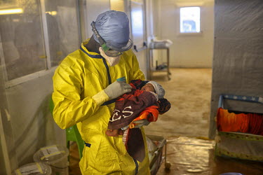 A MSF (Doctors Without Borders) health worker takes care of Nubia Soumah who is infected with Ebola. Her mother Nubia Soumah died of the virus 12 days before and Mamasta now receives treatment from MS...