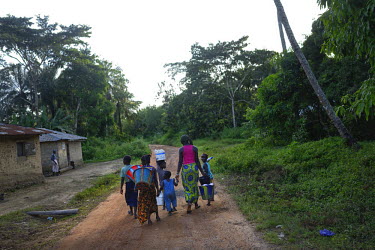 Members of the family of Seydouba Soumah (40) walk freely in their village. Soumah's two wives died of Ebola recently and four of his sons are also infected and have been isolated in a treatment cente...