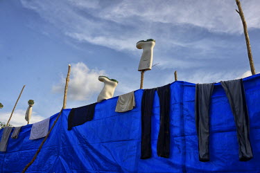 Boots hang out to dry in the sun in a camp that health workers have set up in the village of Tana to fight against the last cases of Ebola in Guinea. Forecariah prefecture is the last known place on e...