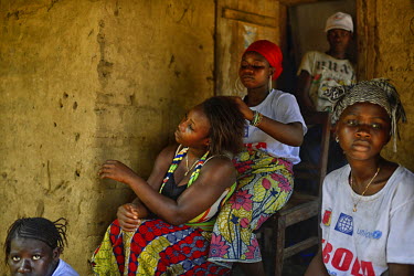 A group of women sit at the door of a house in the village of Tana where some of the last cases of Ebola were found recently. Forecariah prefecture is the last known place on earth with Ebola. Though...