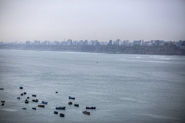 Boats and highrise housing on Lima's Pacific shore.