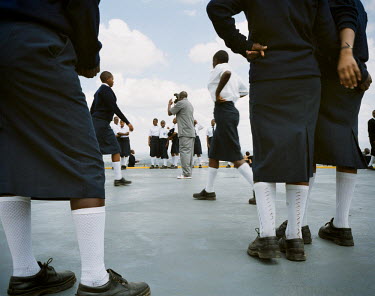 Young girls at a private school in Nairobi are photographed at the top of the ICEA building, the highest in the city, during a school visit.