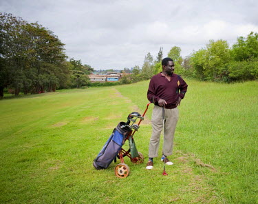 Ousmane playing a round of golf at the Royal Nairobi Golf Club. The club is next to Kibera (the roofs are visible in the background) which is one of the largest slums in Africa. Ousmane grew up and st...
