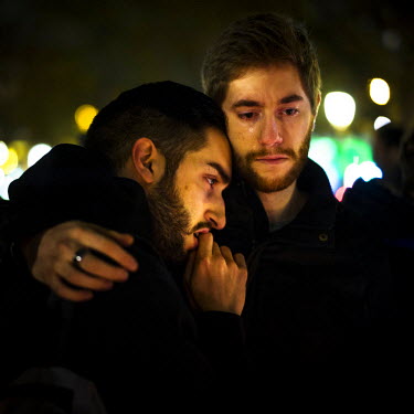 Two young men pay their respects to those killed during the 13 November terrorist attacks in Paris at an impromtu memorial on the Place de la Republique. On 13 November 2015, coordinated attacks at si...