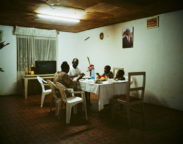A family dinner at the home of Guy Desire Nouboussi in the small town of Buea. He is director in a small primary school and also, to supplement his income, a farmer and has just started to try a marke...