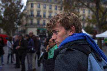 A young man at one of the many impromptu memorial sites created by the public at the sites of the atrocities and in the Place de la Republique as Paris struggles to come to terms with the events of 13...