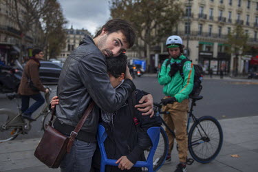 A young couple embrace at one of the many impromptu memorial sites created by the public at the sites of the attrocities and in the Place de la Republique as Paris struggles to come to terms with the...