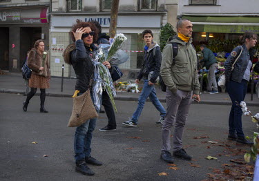 An emotional woman at one of the many impromptu memorial sites created by the public at the sites of the attrocities and in the Place de la Republique as Paris struggles to come to terms with the even...