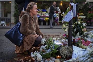 A young woman at Place de la Republique, one of the many impromptu memorial sites made by the public as Paris struggles to come to terms with the events of 13 November 2015.On 13 November 2015, coordi...