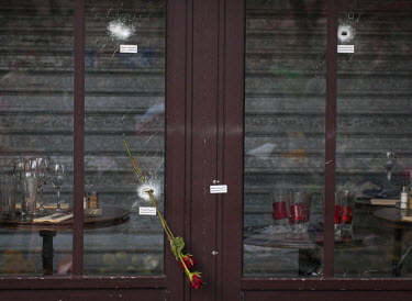 Flowers pushed through a bullet hole in the window of La Bonne Biere bar, one of the sites of the 13 November terrorist attacks. On 13 November 2015, coordinated attacks at six locations across Paris...