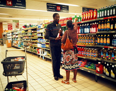 A Mozambican couple shopping in a supermarket in South Africa, where goods are cheaper and more plentiful than in their in own country.