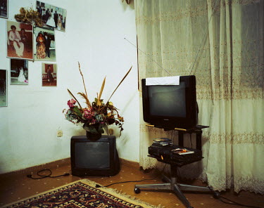 Televisions in the living room at Joseph Pousseu's home.