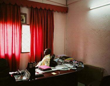 Joseph Pousseu in his department head office within the Ministry of Promotion of Women.