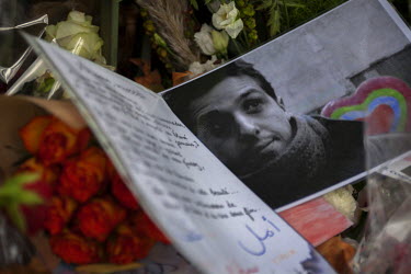 A photograph of a man killed during the 13 November terrorist attacks placed at one of the many impromptu memorial sites created by the public at the sites of the atrocities and in the Place de la Rep...