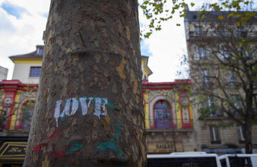 A stencil of the word 'LOVE' on a tree near one of the many impromptu memorial sites created by the public at the sites of the atrocities and in the Place de la Republique. On 13 November 2015, coordi...