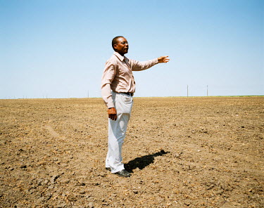 Daniel Congolo stands in a part-prepared field which is to be used for rice cultivation once the water supplies have been installed. The farm has a total of 14 hectares, of which 10 are already devote...