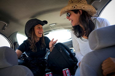 Marah (left), one of the "Speed Sisters", sits in the back of a car with one of her friends. The "Speed Sisters" is an all women car racing team, the only one of its kind in the Palestinian Territorie...