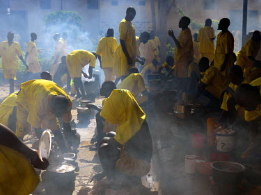 Inmates cooking food, provided by their families, in a courtyard in Kigo Prison, a high security facility which accommodates 1,175 prisoners.