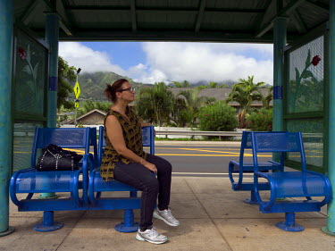 Terri Davies waits for a bus after a cancelled job interview. The bus network is vital for the homeless but buses run only every hour. She has been helped by the Ho'omoana Foundation with finding work...