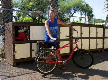 Mark Rasmus, 53. Mark has lived on Maui since 1989. He became homeless after losing his apartment in a fraud, and ended up in prison. He lives on the beach in Lahina and cycles everyday to store his v...