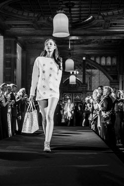 A model sashays down the runway (catwalk) during a fashion show at the Badrutt Hotel.