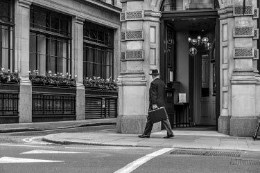 A businessman with a briefcase walking in the City of London.