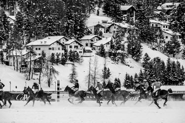 Teams Cartier and Trois Pommes compete during a Snow Polo match.