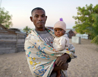 A father with his daughter in the early morning after a night of harvesting sea cucumbers.