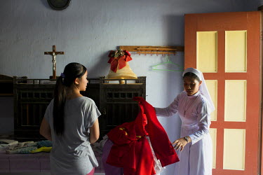A nun prepares the priest's garments for mass on a Sunday in a catholic church in Banda Aceh.