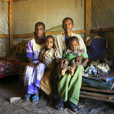 A refugee family from the Mbororo (Wodaabe) ethinc group in Central African Republic pose for a picture in their shelter in the Gado Refugee Camp.  Cameroon is home to over 230,000 refugees from neigh...