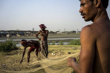 Fishermen folding their nets on the banks of river Yamuna near the Okhla Barrage. The river Yamuna is the primary source of Delhi's water but with its high population density and rapid industrialisati...