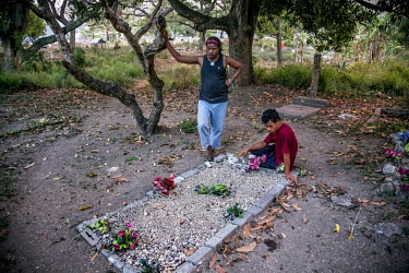 'Speedy' and his friend Toua (20) visiting grave, in Hanuabada village, of their friend Vagi who died from AIDS at the age of 38. Hanuabada/Elevala village is considered one of the few places in PNG w...