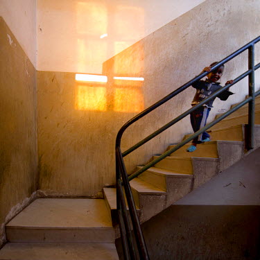 A child on the entrance staircase at the former Alfa Romeo building (Societa Anonima Alfa Romeo SAAR). The city is a showcase of 1930s Italian Art Deco architecture. Initially created by colonial-era...