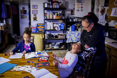 Mary Kiyutellukinguk, who was born in Nome, Alaska but has lived all her life in Shishmaref,m with her granddaughters Kiyeivi (7) and Kalaya (3) after school while their mother is at work. Shishmaref...