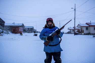 Fred Weyiouanna, 32 years old, and a life long resident with his loaded Ruger 77 rifle that he uses to hunt caribou. Caribou meat is a major source of food for residents of the town. Shishmaref is a b...