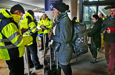 Security personnel check and photograph the photo ID docuements of passengers travelling from Copenhagen airport in Denmark to the Swedish city of Malmo.  On Monday 4 January 2016, Sweden passed a la...