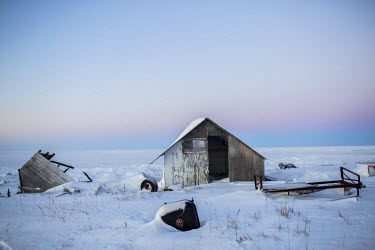 During past storms, and as a result of coastal erosion, various structures have toppled over. Shishmaref is a barrier island with a population of less than 600 Alaska native Inupiaq people located 30...