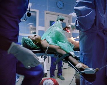 A patientis prepared for an procedure in a NEST private healthcare operating theatre. NEST offers a complete medical service for women and young children, especially paediatric and maternity services....
