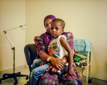 A four year old child waiting with his mother to be vaccinated at a NEST private healthcare facility. The vaccine is around five times cheaper than one of the country's established private clinics and...