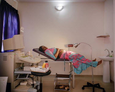 A woman waits to be examined by a gynecologist, shortly after giving birth by cesarean section at a NEST facility. Private healthcare provider NEST, offers a complete medical service for women and you...