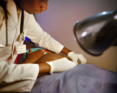 A gynecologist examines a patient shortly after giving birth by cesarean section at a NEST facility. Private healthcare provider NEST, offers a complete medical service for women and young children, e...