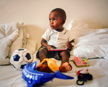 A child plays on his bed following an operation at a NEST private health care facility. NEST offers a complete medical service for women and young children, especially paediatric and maternity service...