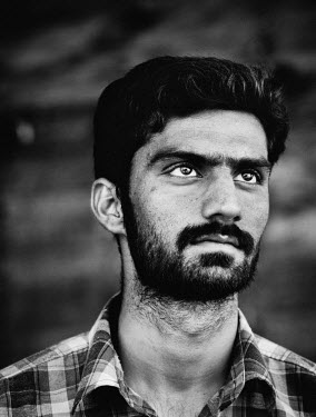 Talha Munawas (23) one of ten Pakistanti boat builders constructing a traditional wooden Iranian Lenj boat in the Gouran boatyard. The workers who will be paid a thousand US Dollars a year for two yea...