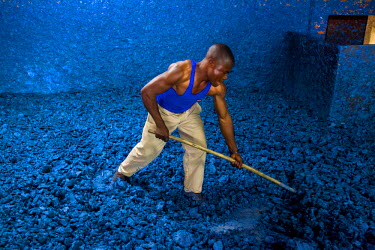 A worker at the Savonnerie Industrielle de Butembo (SAIBU) whose main product is bars of blue soap. Bad roads and insecurity means the company generally can only sell its products locally.